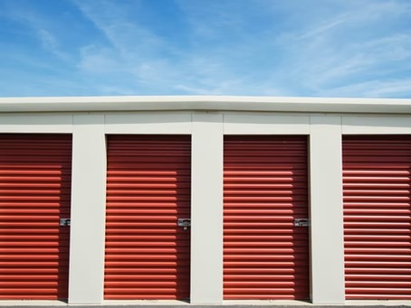 A row of closed red doors beneath an open blue sky